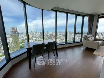 Stunning high-rise living room with panoramic city views and modern furnishings.