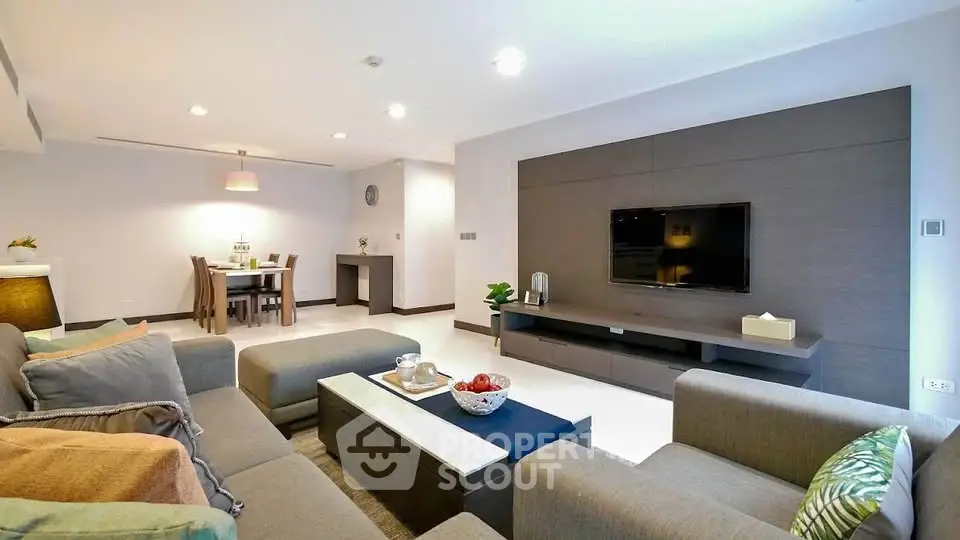 Spacious modern living room with elegant decor and dining area, perfect for entertaining.