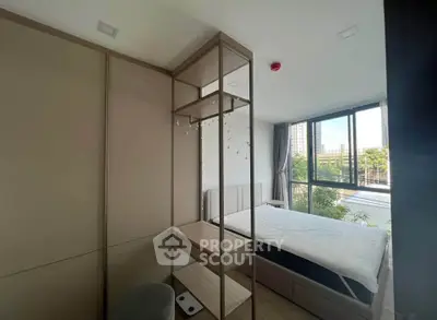 Modern bedroom with large window and minimalist decor in urban apartment