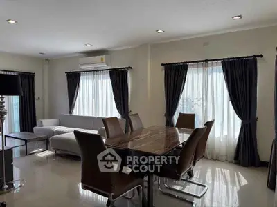 Spacious modern living room with elegant dining area and natural light