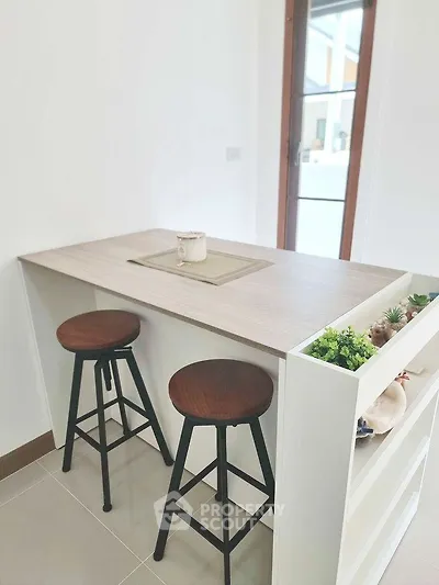 Modern kitchen with stylish bar stools and sleek countertop design