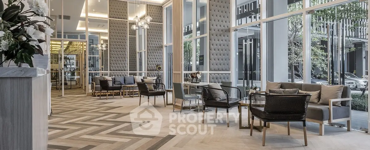 Luxurious modern lobby with elegant seating and floor-to-ceiling windows in upscale building.