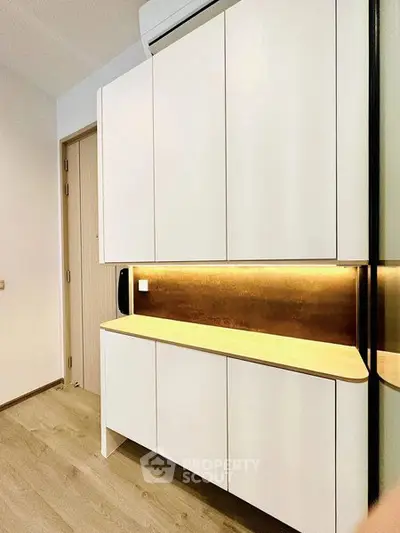Modern kitchen with sleek cabinetry and warm lighting
