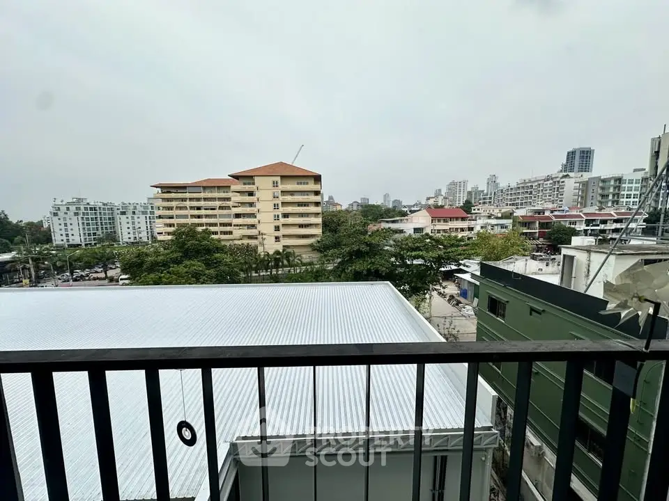 Urban balcony view with cityscape and greenery, perfect for modern living.