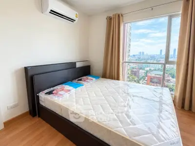 Modern bedroom with large window offering stunning city views and natural light.