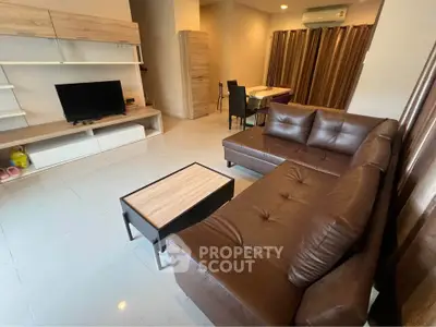 Spacious living room with modern furniture and open layout, perfect for relaxation and entertainment.
