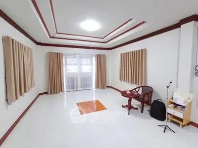 Spacious unfurnished living room with large windows and elegant ceiling design