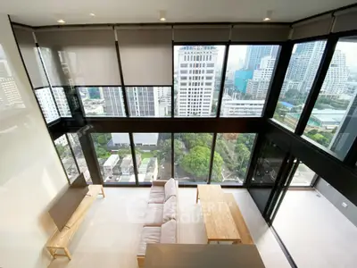 Stunning corner unit with floor-to-ceiling windows offering breathtaking city views in a modern living room.