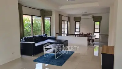 Spacious living room with modern furniture and large windows for natural light.