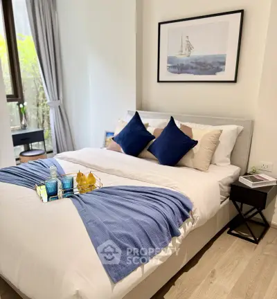 Elegant bedroom with stylish decor and natural light, featuring a cozy bed and modern furnishings.