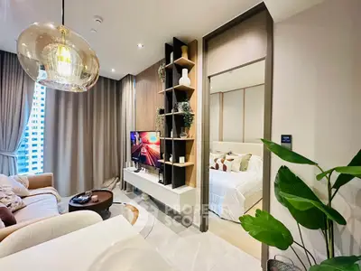Modern living room with stylish decor and cozy bedroom view, perfect for urban living.