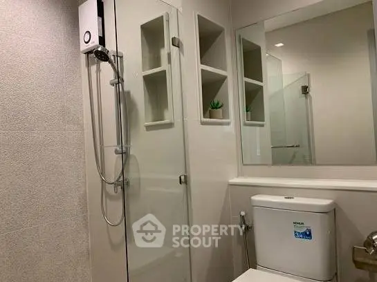 Modern bathroom with glass shower and sleek fixtures