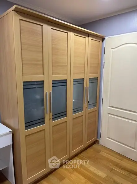 Spacious wooden wardrobe in a modern bedroom with elegant design.