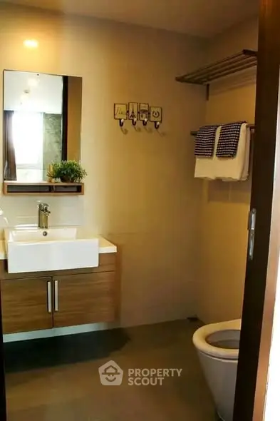 Modern bathroom with sleek vanity and towel rack in a stylish apartment.