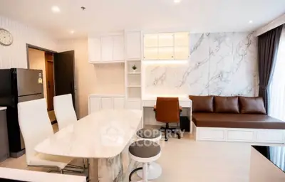 Modern open-layout living room with marble accents and stylish furniture