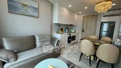 Modern living room with integrated kitchen featuring sleek appliances and elegant dining area.