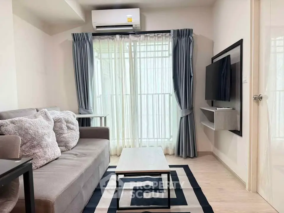 Modern living room with cozy sofa, stylish rug, and wall-mounted TV, perfect for relaxation and entertainment.