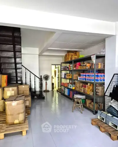 Spacious storage area with organized shelves and boxes, ideal for inventory management.