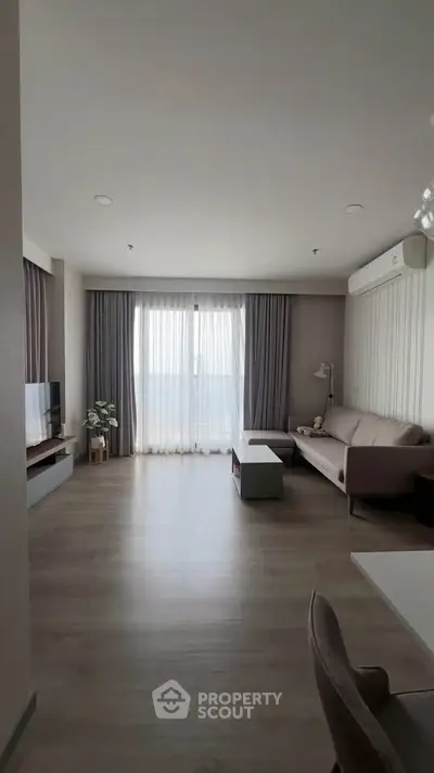 Spacious modern living room with large windows and elegant decor