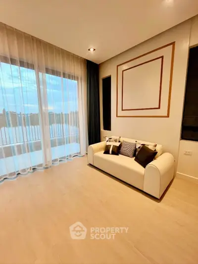 Elegant living room with modern decor and large windows offering a scenic view.
