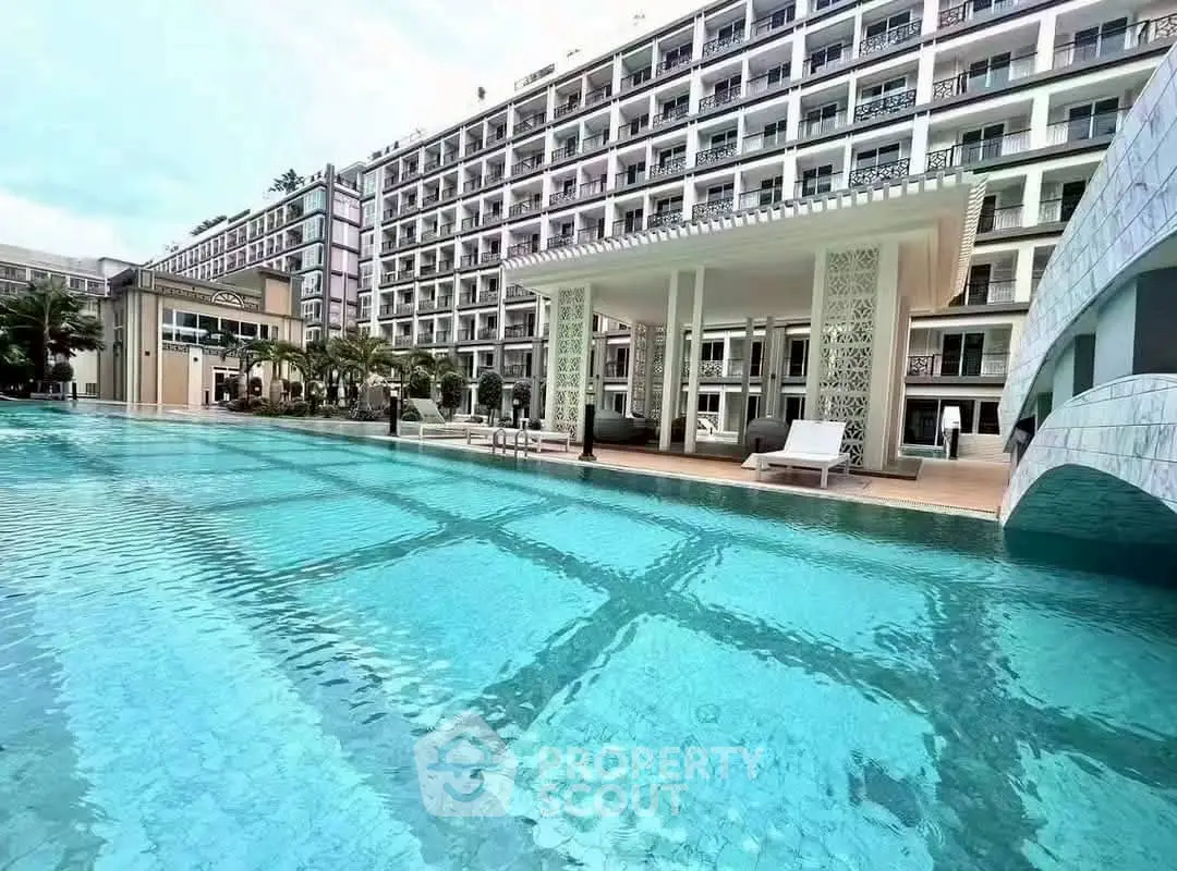 Luxurious apartment complex with stunning poolside view and modern architecture.