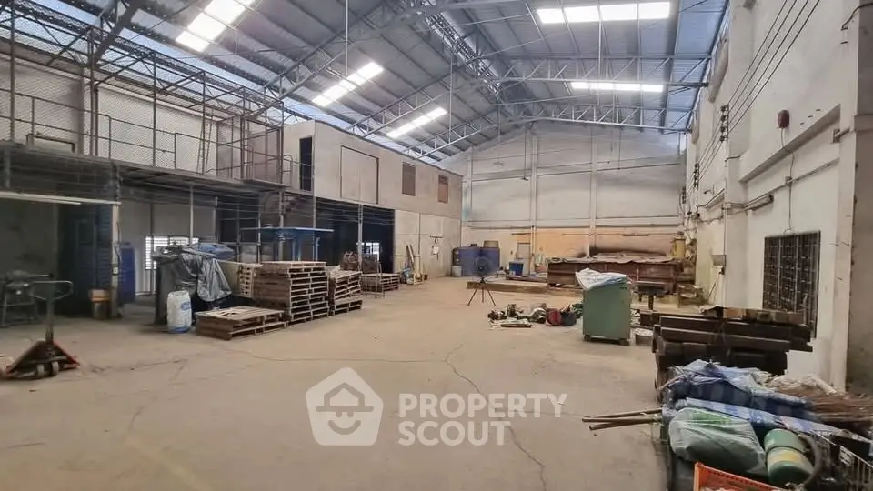 Spacious industrial warehouse with high ceilings and ample storage space.