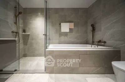 Luxurious modern bathroom with elegant bathtub and glass shower enclosure
