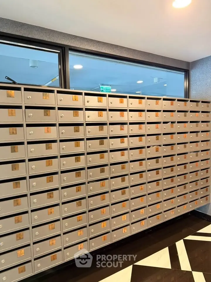 Modern apartment building mailboxes in a sleek lobby area.