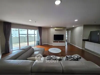 Spacious modern living room with large windows and stylish furniture