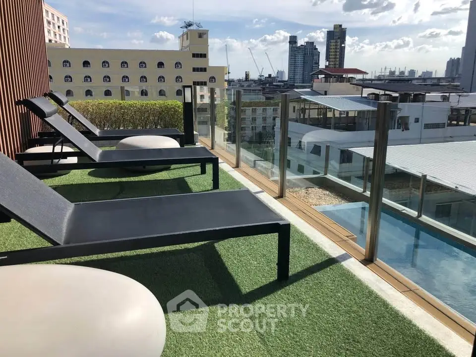 Luxurious rooftop pool area with stunning city views and modern lounge chairs.