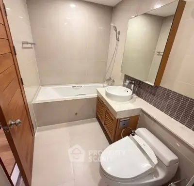 Modern bathroom with bathtub and sleek fixtures in a contemporary apartment.