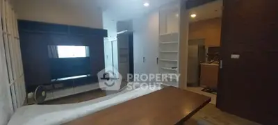 Cozy living room with modern furniture and open kitchen layout in a stylish apartment.