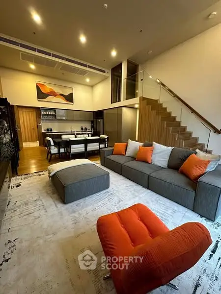 Modern living room with stylish furniture and open kitchen layout
