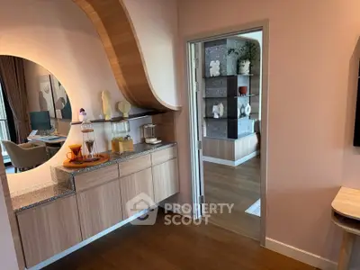 Stylish modern interior with wooden accents and open layout, featuring a cozy living area and decorative shelving.