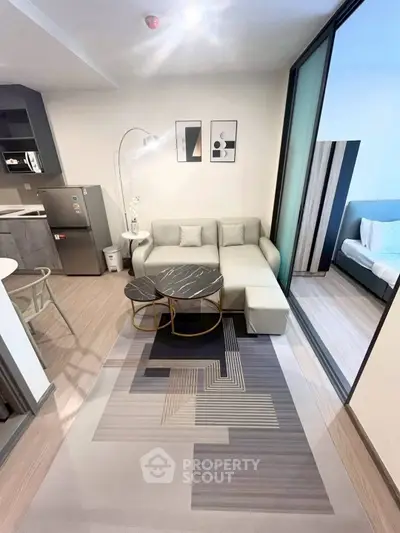 Modern living room with stylish decor and open layout adjacent to a cozy bedroom.