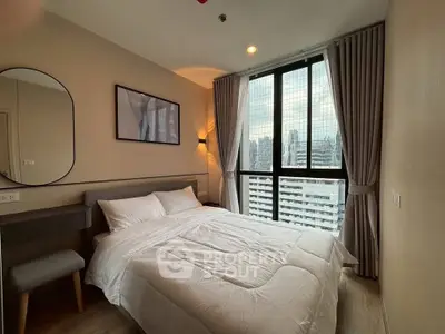 Modern bedroom with city view, featuring cozy bed and stylish decor.