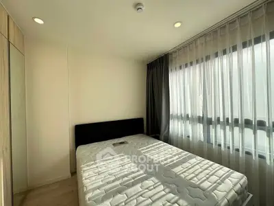 Bright bedroom with large window and modern decor