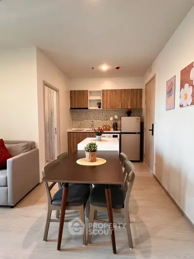 Modern open-layout kitchen with dining area and cozy living space