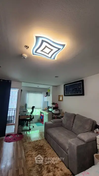 Modern living room with stylish ceiling light and cozy sofa