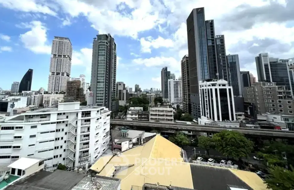 Stunning cityscape view showcasing modern skyscrapers and urban skyline under a vibrant blue sky.