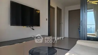 Modern living room with wall-mounted TV and balcony view