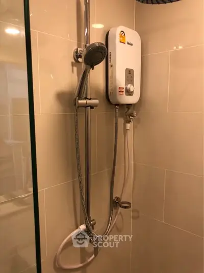 Modern bathroom with sleek shower and water heater in a stylish apartment.