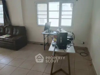 Spacious living room with natural light and modern setup