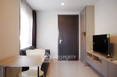 Modern living room with sleek furniture and natural light, perfect for cozy urban living.