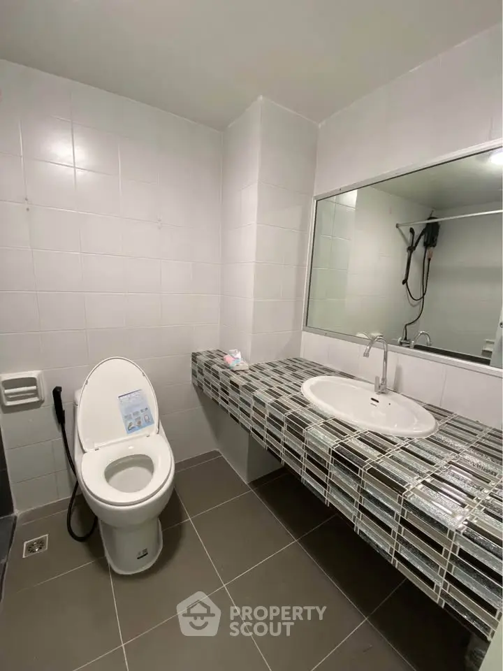 Modern bathroom with sleek tile design and large mirror