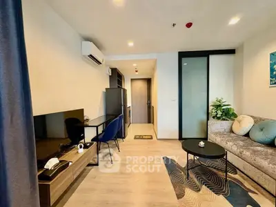 Modern living room with stylish decor and open layout, featuring a cozy sofa and sleek TV unit.