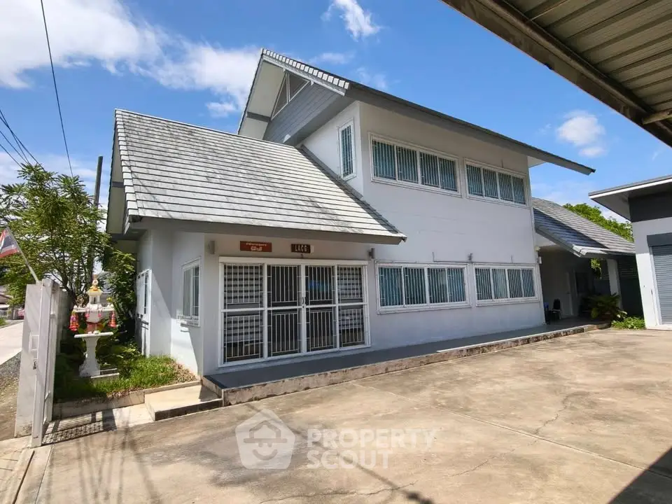 Charming two-story house with modern design and spacious driveway in a serene neighborhood.