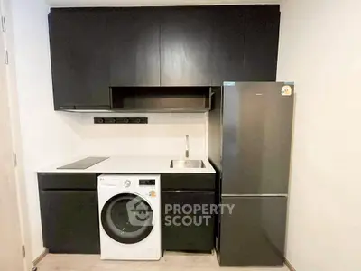 Modern kitchen with sleek black cabinetry and integrated appliances