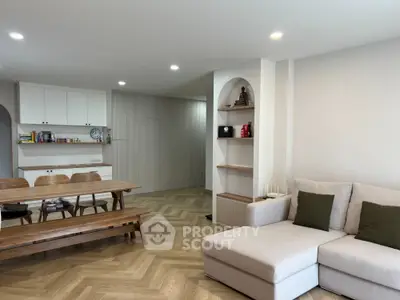 Spacious living room with modern decor and wooden flooring