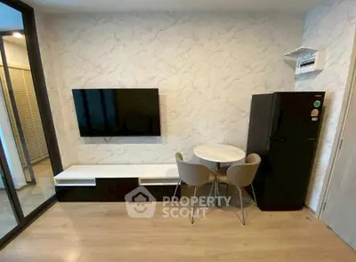 Modern living room with wall-mounted TV and compact dining area